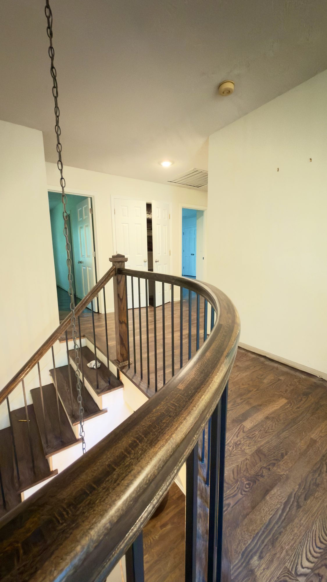 Curved staircase and hardwood by DCQ Wood Flooring