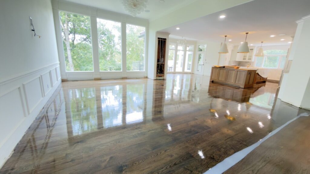 Hardwood Refinish: Dark stain and high-gloss coat across an open living area